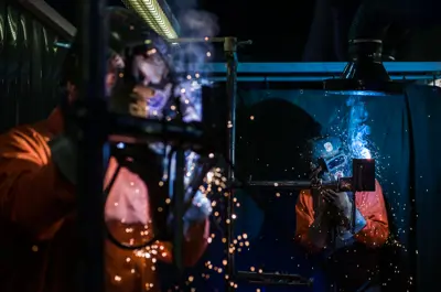 Students practicing welding techniques in a hands-on lab